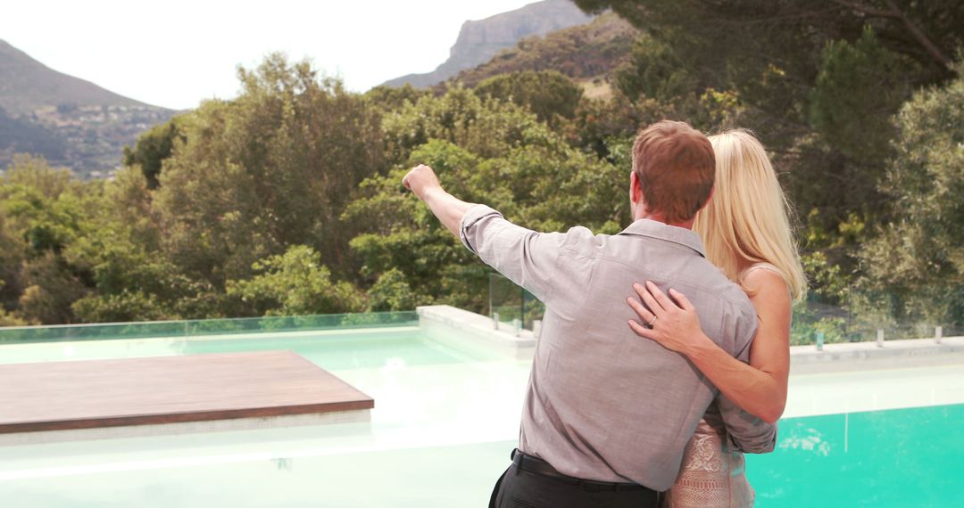 Couple Enjoying Mountainous View by Luxurious Pool - Free Images, Stock Photos and Pictures on Pikwizard.com