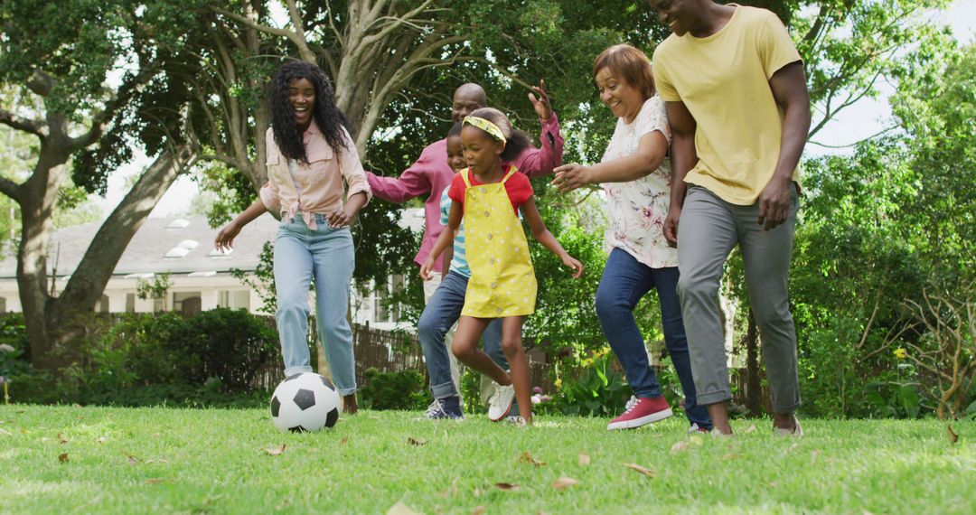 Image of happy african american family playing football in garden - Free Images, Stock Photos and Pictures on Pikwizard.com