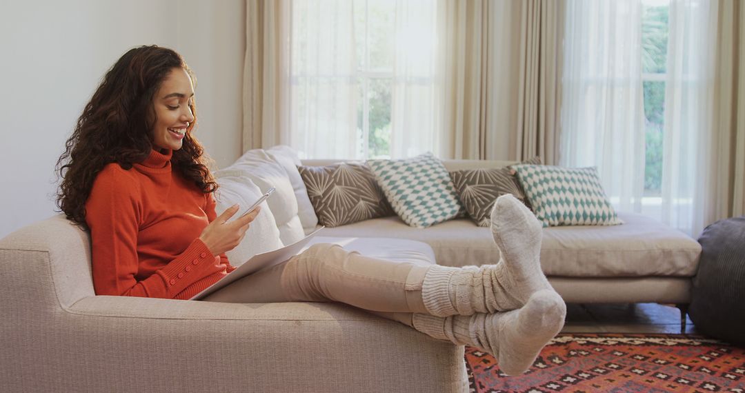 Young Woman Relaxing on Sofa at Home with Book and Hot Beverage - Free Images, Stock Photos and Pictures on Pikwizard.com