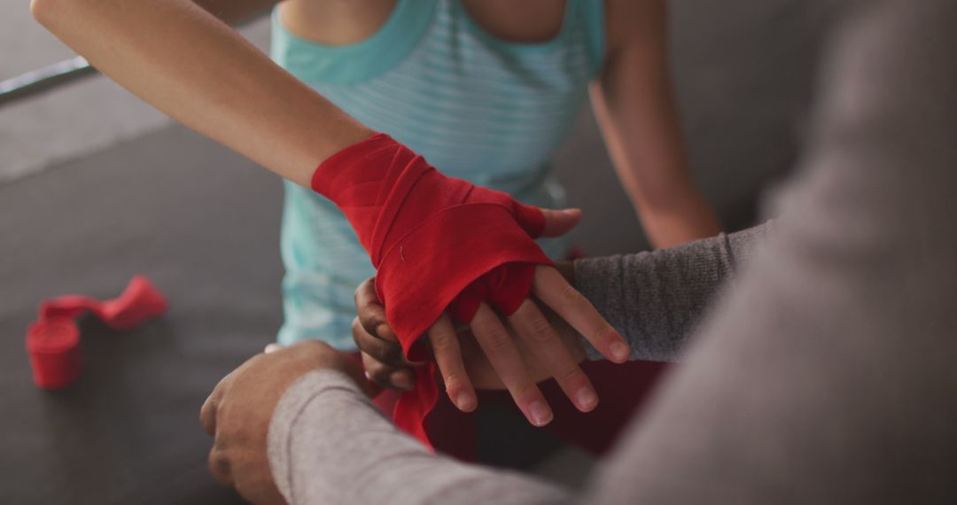 Trainer Wrapping Red Hand Wraps on Female Athlete's Hands - Free Images, Stock Photos and Pictures on Pikwizard.com