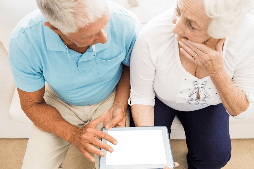 Senior Couple Discussing Tablet Content with Transparent Screen