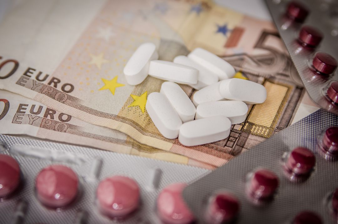 Euro Banknotes and Pills Conceptualizing Healthcare Costs
