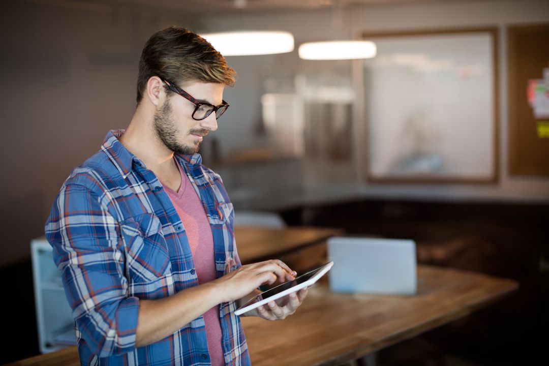 Bearded Professional Using Tablet in Modern Office Environment