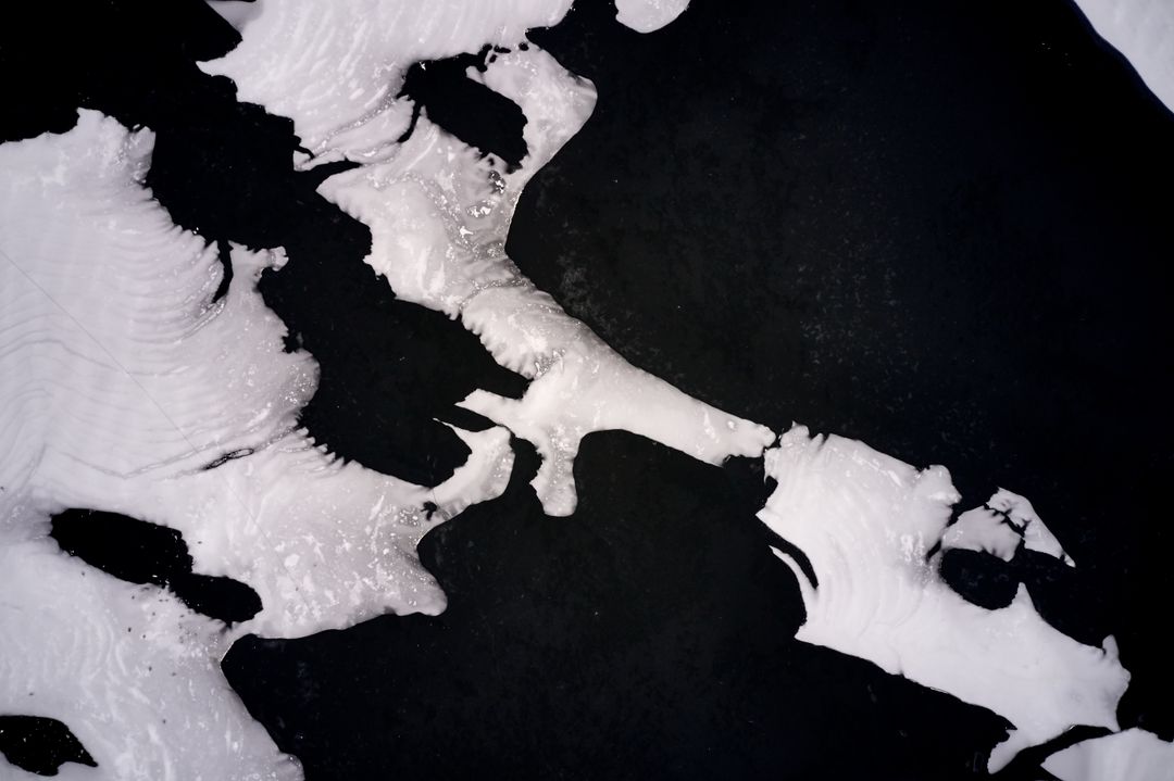 Abstract Aerial View of Ice Formations on Black Water