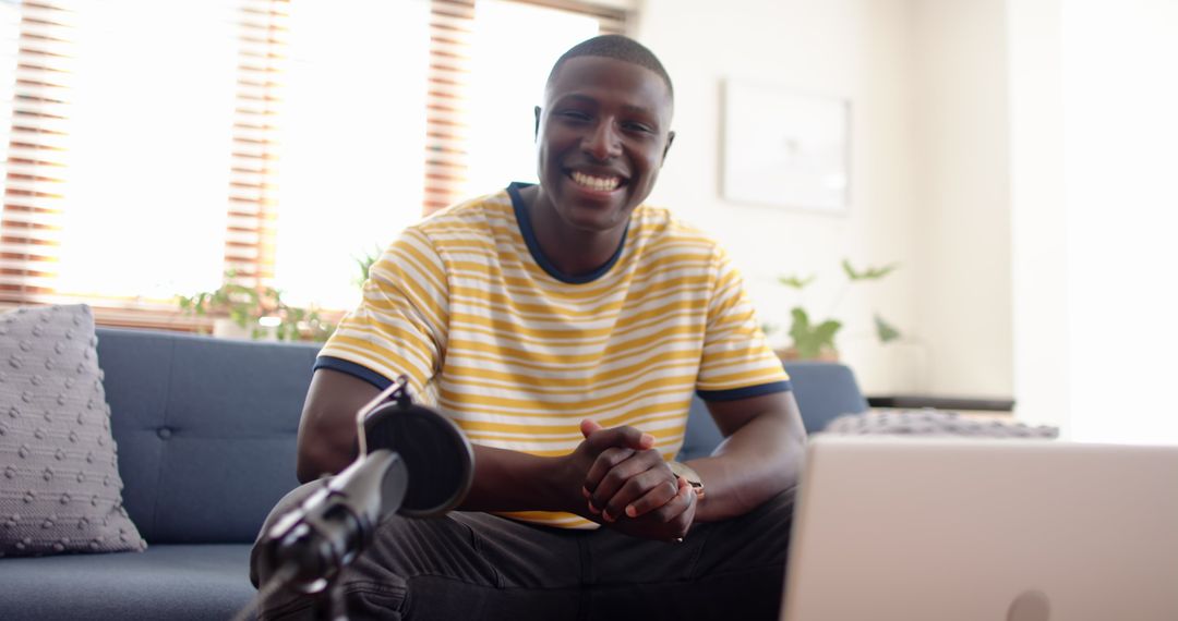 Smiling Man Hosting Podcast in Cozy Living Room Setting