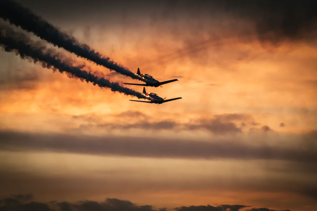 2 Jet Planes on Sky Under Orange Clouds - Free Images, Stock Photos and Pictures on Pikwizard.com