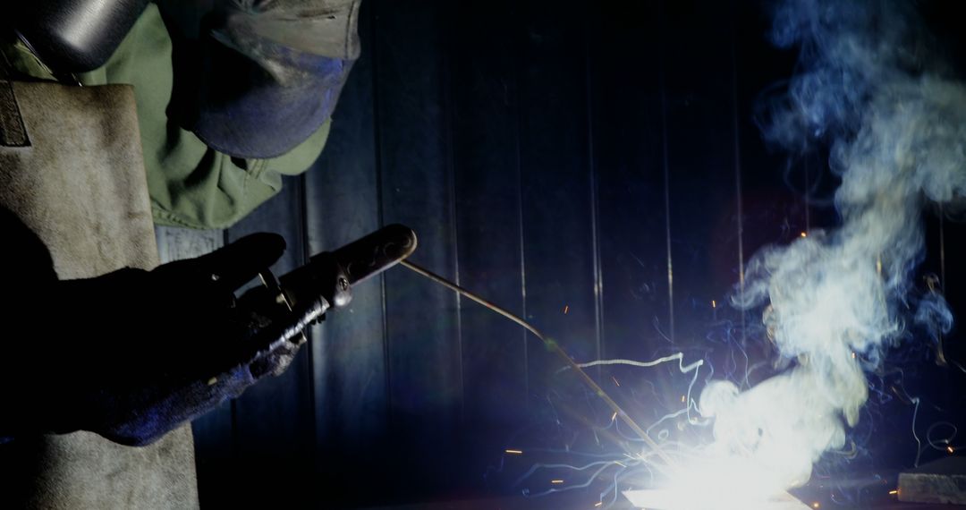 Welder Operating in Dimly Lit Workshop, Sparking Bright Light - Free Images, Stock Photos and Pictures on Pikwizard.com