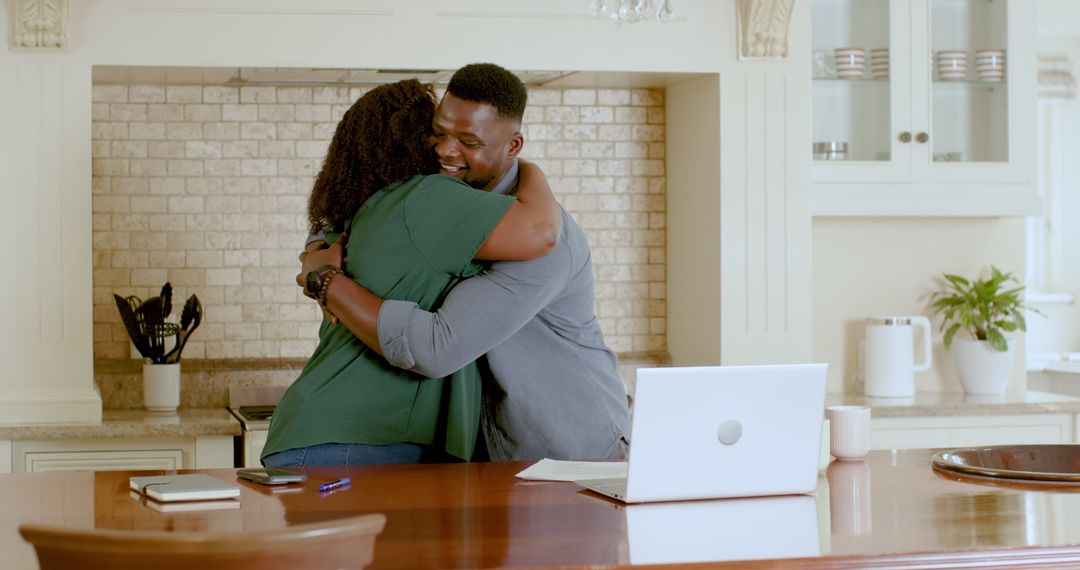 African American Couple Embracing While Discussing Plans at Home