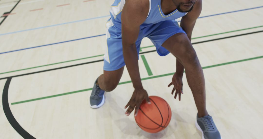 Focused Basketball Player Dribbling on Indoor Court - Free Images, Stock Photos and Pictures on Pikwizard.com