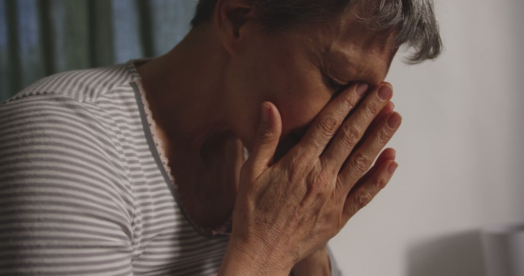 Elderly Woman In Striped Shirt Grieving - Free Images, Stock Photos and Pictures on Pikwizard.com