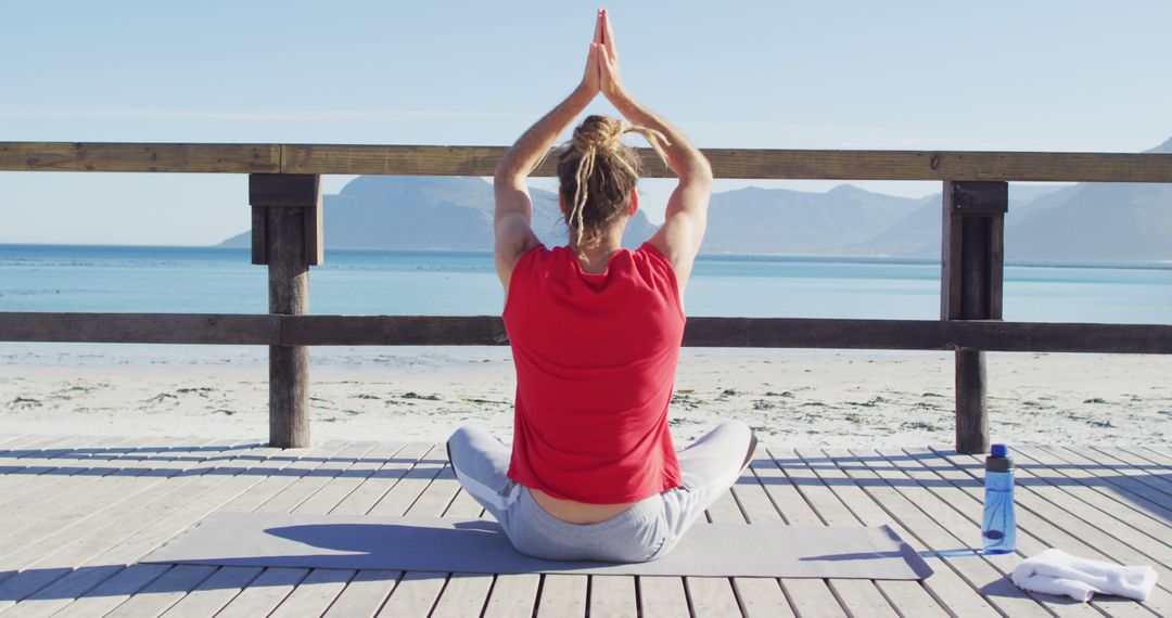 Woman Practicing Yoga on Beach Deck with Ocean View - Free Images, Stock Photos and Pictures on Pikwizard.com