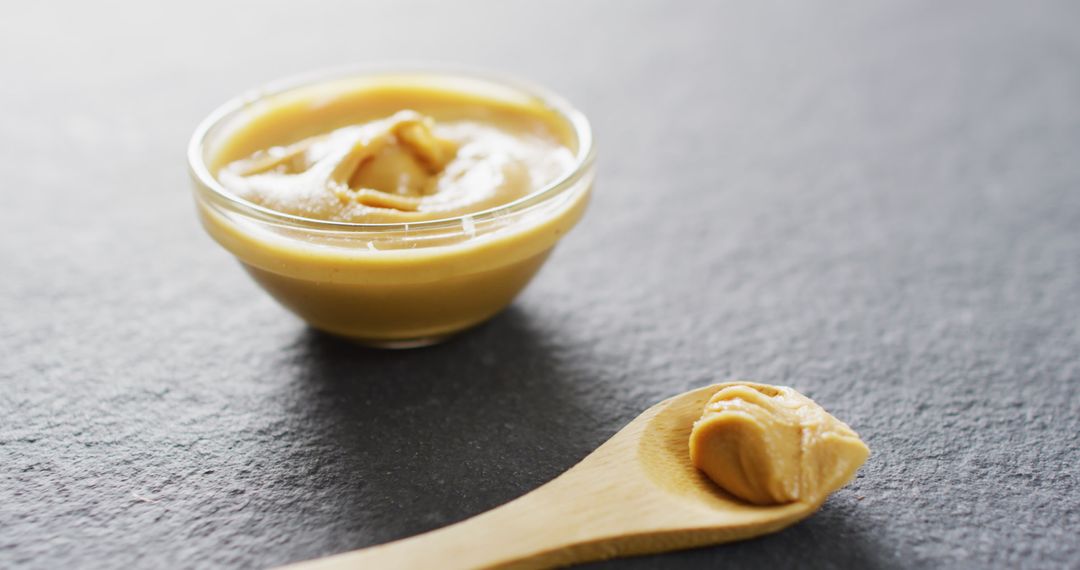 Smooth Peanut Butter in Glass Bowl and Wooden Spoon - Free Images, Stock Photos and Pictures on Pikwizard.com