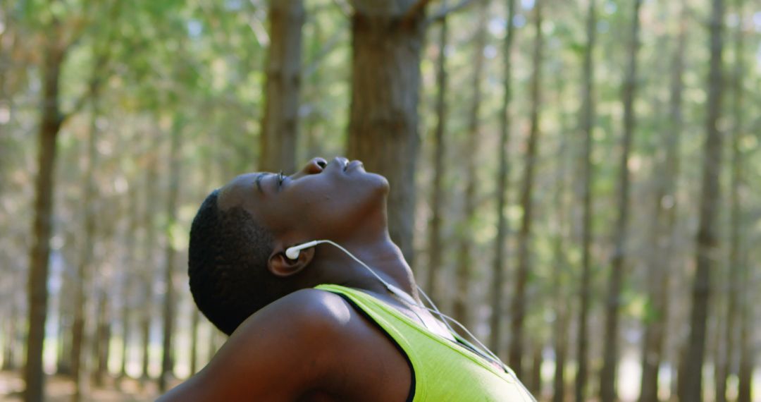 Woman Stretching Outdoors Listening to Music in Forest - Free Images, Stock Photos and Pictures on Pikwizard.com