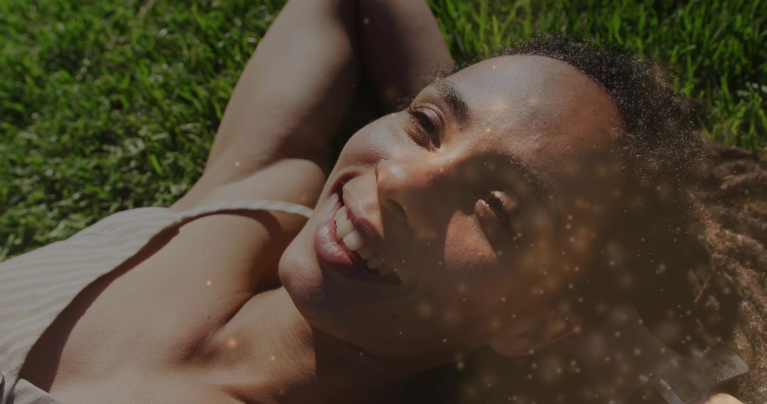 Woman Enjoying Relaxation on Grass with Sparkling Effect Overlay