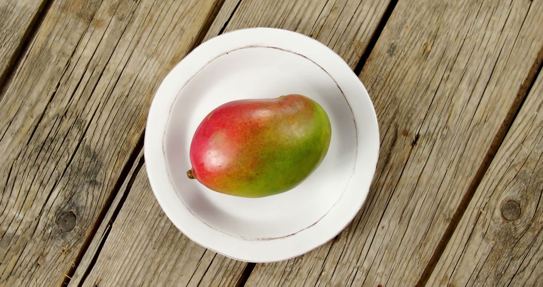 Ripe Mango on White Plate on Rustic Wooden Table - Free Images, Stock Photos and Pictures on Pikwizard.com