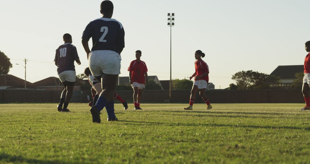 Teams Playing Soccer on Field at Sunset - Free Images, Stock Photos and Pictures on Pikwizard.com