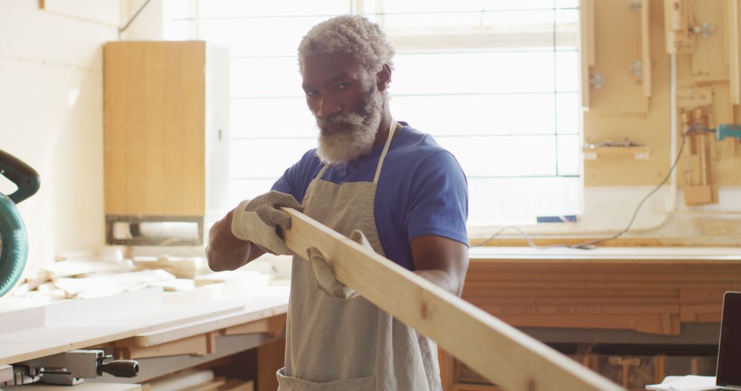 Elderly Carpentry Expert Working on Wooden Plank - Free Images, Stock Photos and Pictures on Pikwizard.com