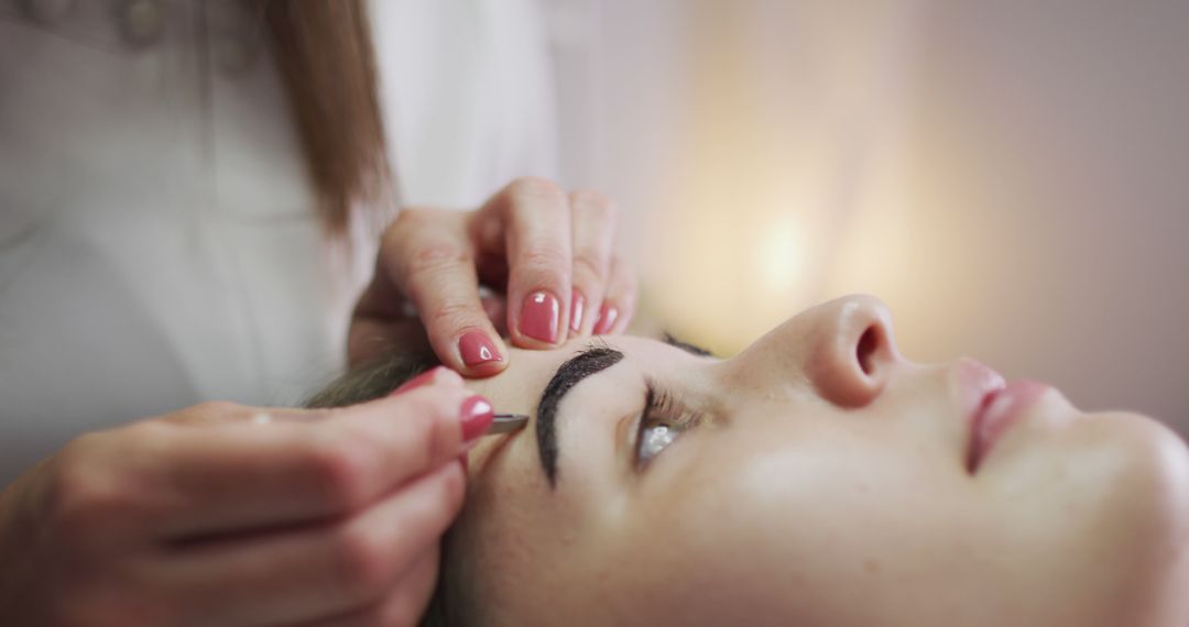 Woman Receiving Professional Eyebrow Shaping Procedure - Free Images, Stock Photos and Pictures on Pikwizard.com