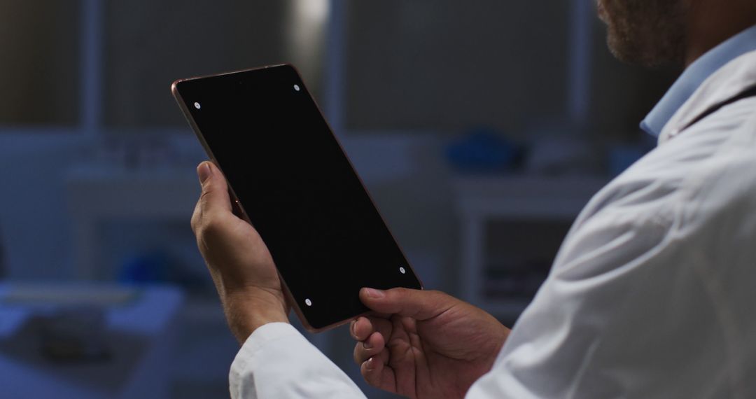 Doctor Examining Tablet in Clinical Environment - Free Images, Stock Photos and Pictures on Pikwizard.com