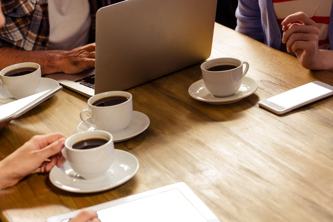 Collaborative Meeting with Transparent Coffee Cups and Tech Devices - Download Free Stock Images Pikwizard.com