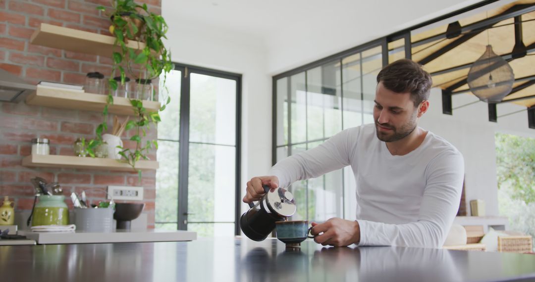 Man Pouring Coffee from French Press in Modern Kitchen - Free Images, Stock Photos and Pictures on Pikwizard.com