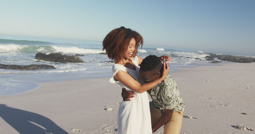 Smiling Couple Enjoying Playful Moment on Beach - Free Images, Stock Photos and Pictures on Pikwizard.com