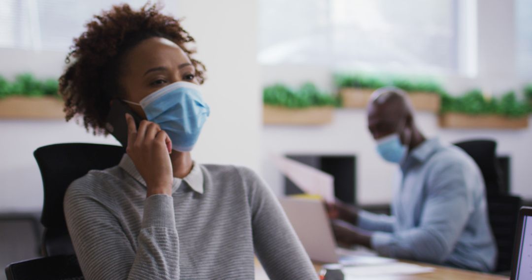 Office Workers Wearing Masks and Social Distancing During Pandemic - Free Images, Stock Photos and Pictures on Pikwizard.com