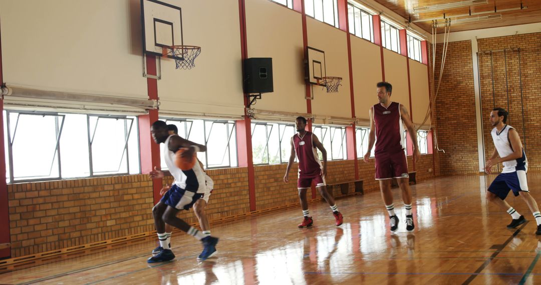 Men Playing Basketball Indoors in Gymnasium Afternoon Light - Free Images, Stock Photos and Pictures on Pikwizard.com