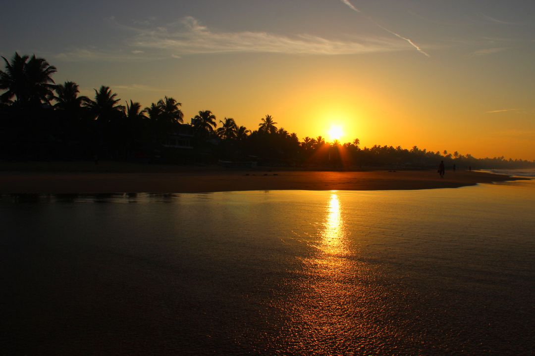 Brilliant Sunset Over Tranquil Beach Waters - Free Images, Stock Photos and Pictures on Pikwizard.com