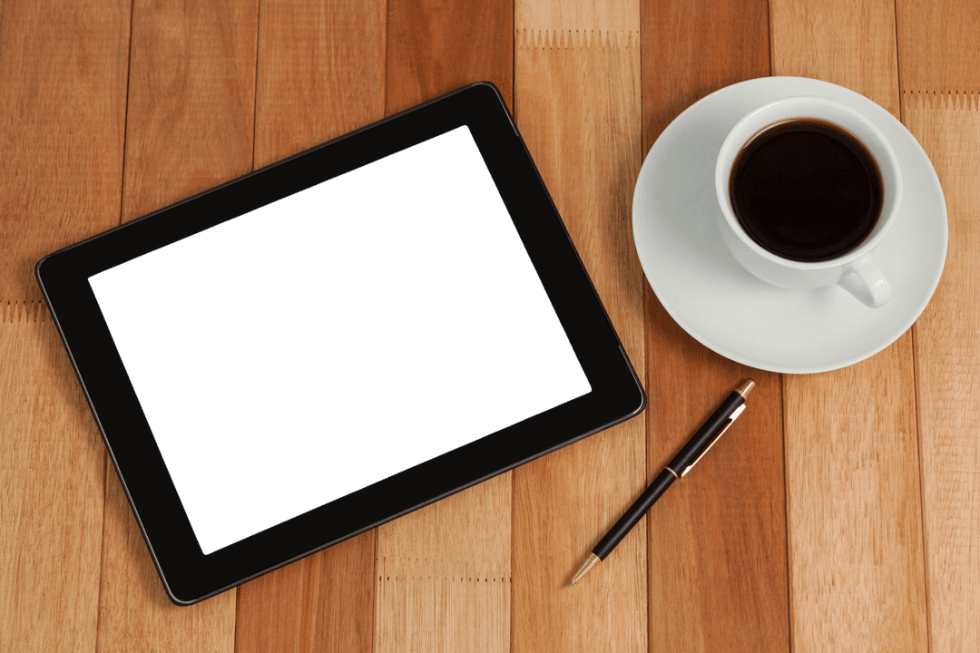 Transparent Digital Tablet on Wooden Surface with Coffee and Pen