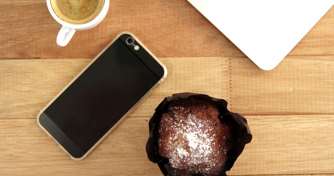 Coffee and Chocolate Muffin with Smartphone and Laptop on Wooden Desk - Free Images, Stock Photos and Pictures on Pikwizard.com