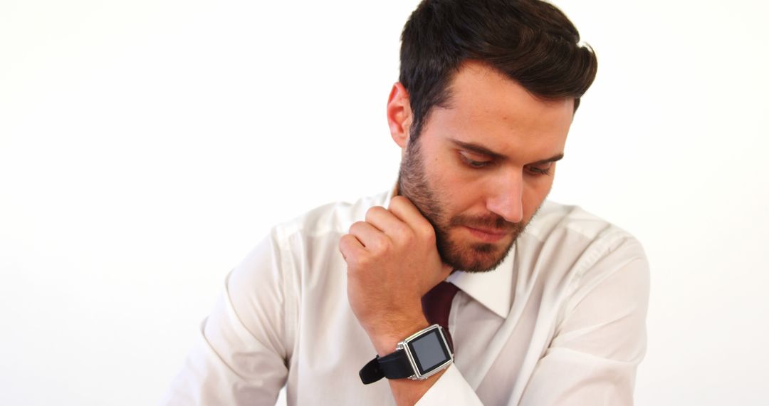 Businessman With Smartwatch, Looking Down Thoughtfully - Free Images, Stock Photos and Pictures on Pikwizard.com