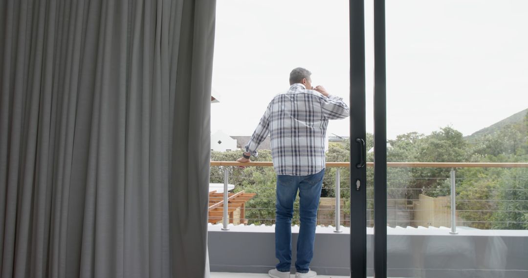 Middle-aged Man Enjoying Scenic Balcony View - Free Images, Stock Photos and Pictures on Pikwizard.com