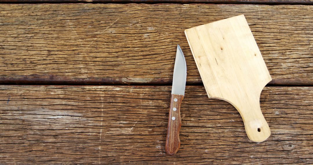 Wooden Cutting Board and Knife on Rustic Wooden Background - Free Images, Stock Photos and Pictures on Pikwizard.com