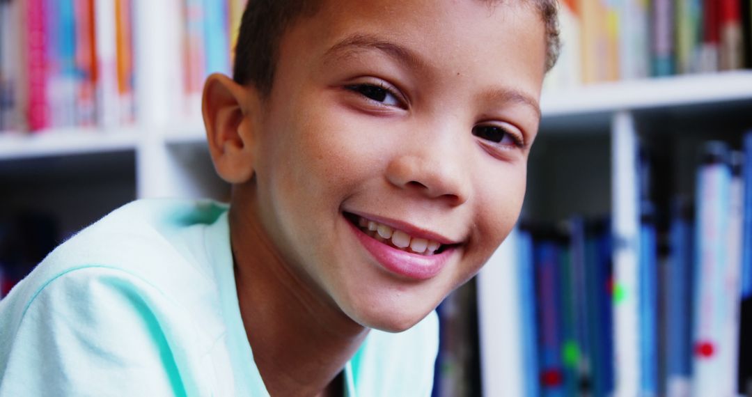 Happy Schoolboy Smiling in a Library