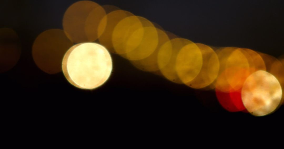 Abstract Golden Bokeh Lights on Dark Background