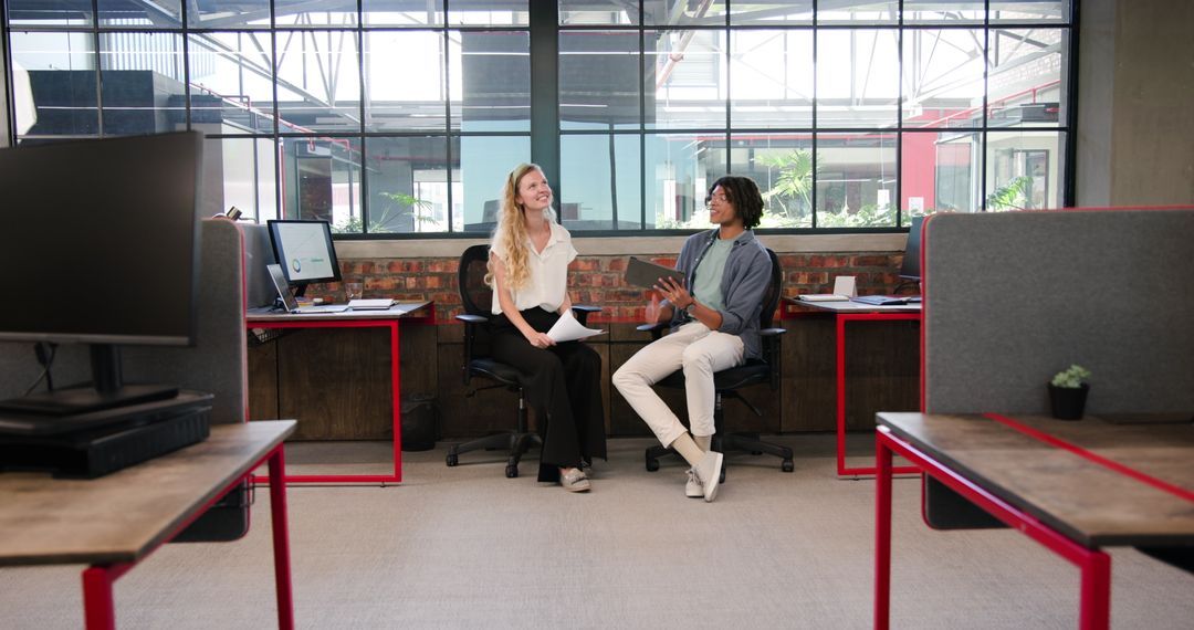 Colleagues in Modern Office Discussing Ideas with Tablet