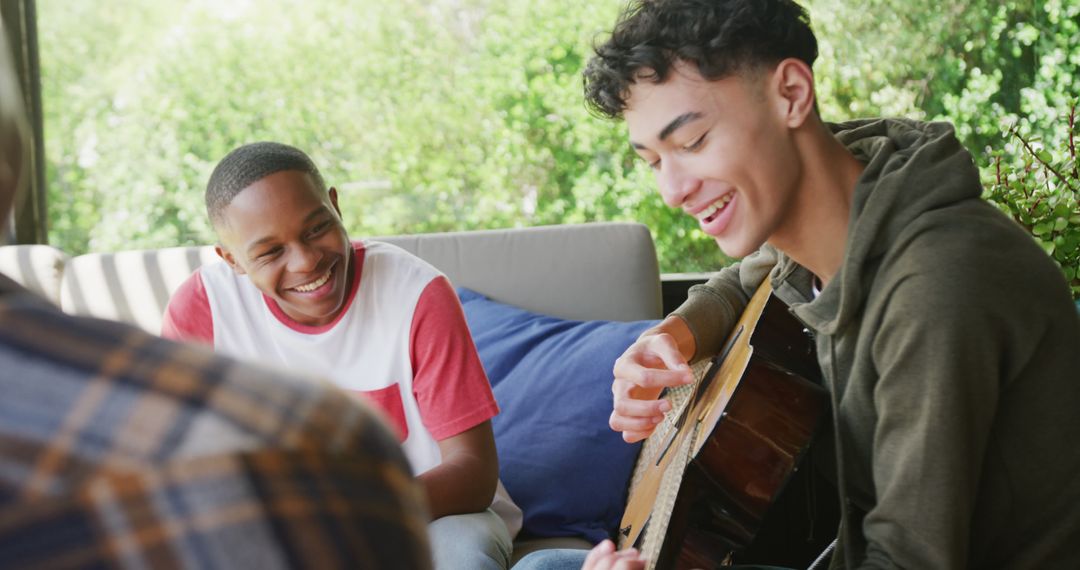 Teenagers Enjoying Guitar Music Together Outdoors - Free Images, Stock Photos and Pictures on Pikwizard.com