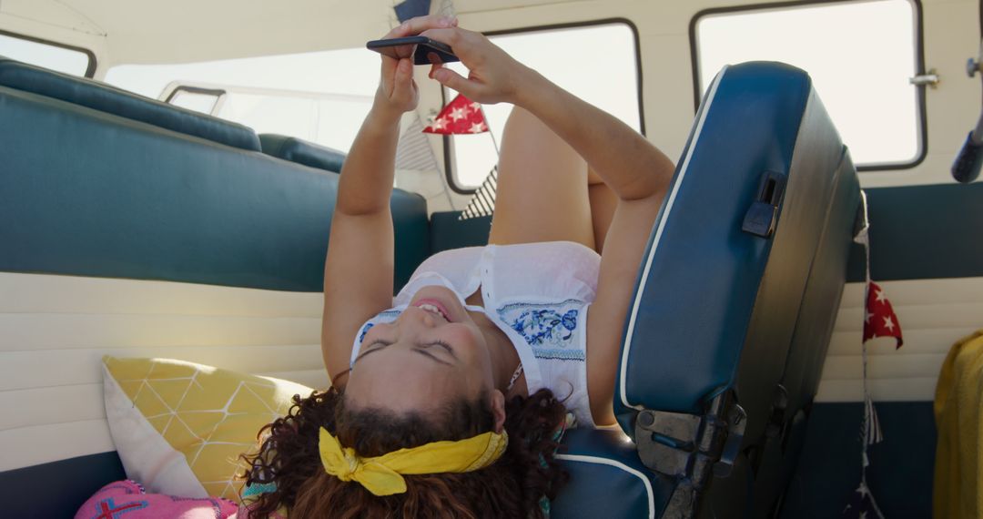 Young Woman Relaxing Inside Camper Van While Using Smartphone - Free Images, Stock Photos and Pictures on Pikwizard.com