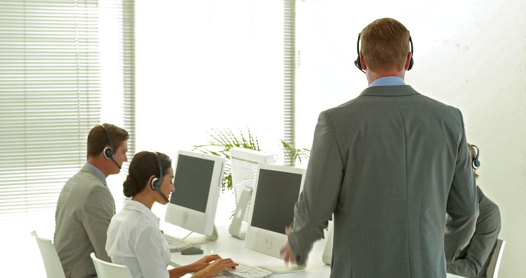 Call Center Team Wearing Headsets Working and Collaborating - Free Images, Stock Photos and Pictures on Pikwizard.com