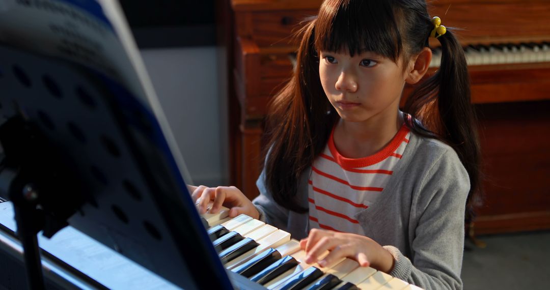 Young Girl Practicing Piano During Music Class At School - Free Images, Stock Photos and Pictures on Pikwizard.com