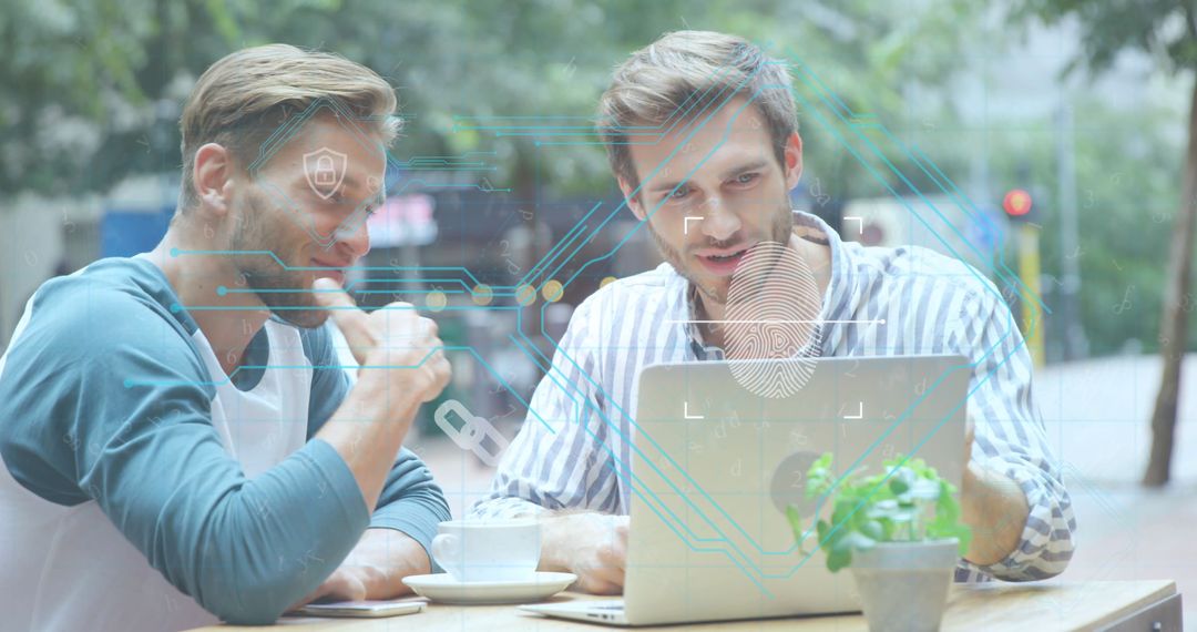 Colleagues Discuss Cybersecurity on Laptop in Casual Outdoor Setting