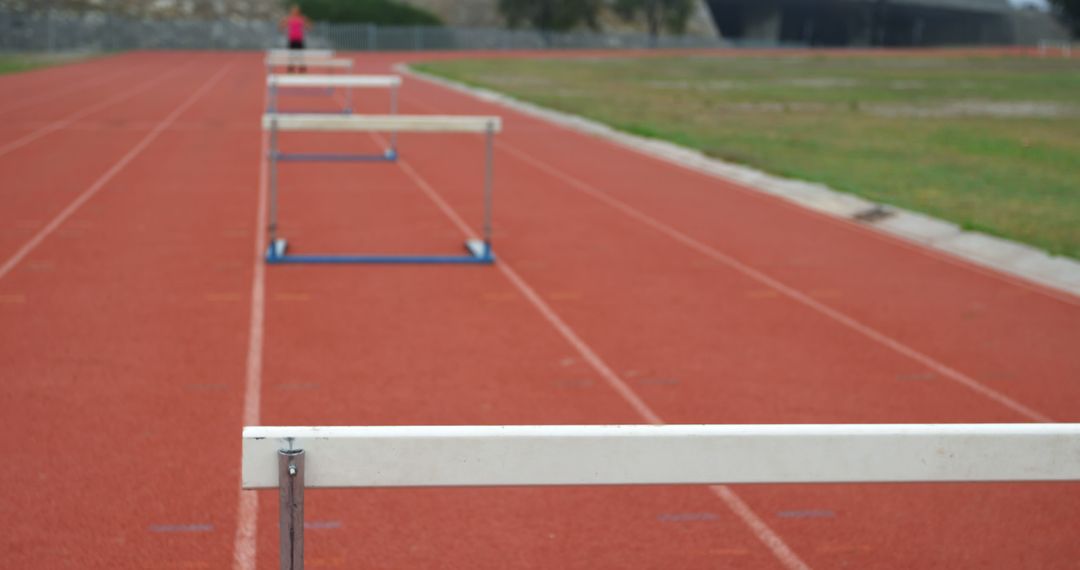 Empty Running Track with Hurdles in Outdoor Stadium - Free Images, Stock Photos and Pictures on Pikwizard.com