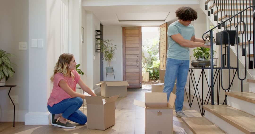 Couple Unpacking Boxes in New Home Interior, Starts Journey with Happiness