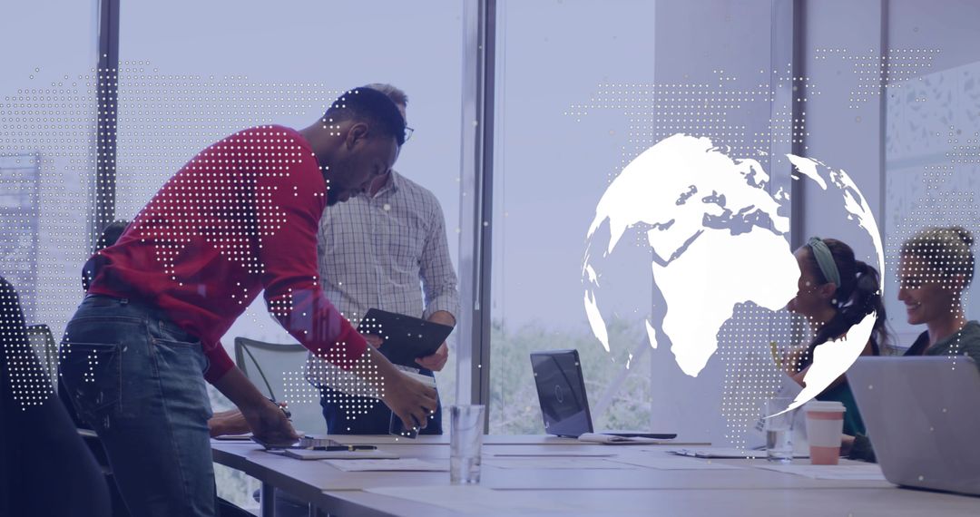 Business team collaborating around conference table with digital globe overlay and laptops