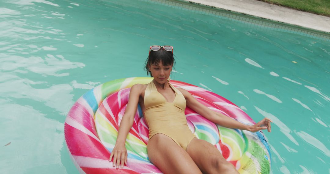 Woman on colorful pool float enjoying summer relaxation - Free Images, Stock Photos and Pictures on Pikwizard.com