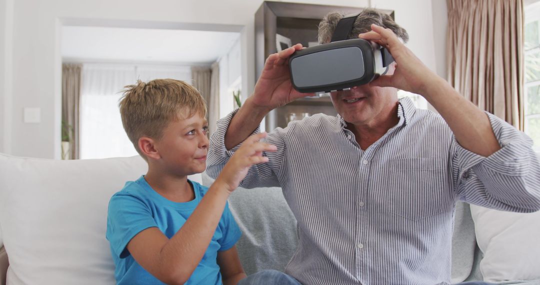 Elderly Man and Boy Exploring Virtual Reality Indoors - Free Images, Stock Photos and Pictures on Pikwizard.com