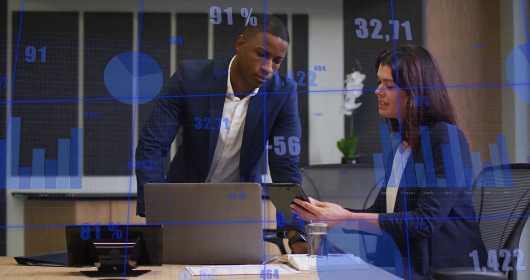 Colleagues Analyzing Financial Data on Digital Devices in Modern Office