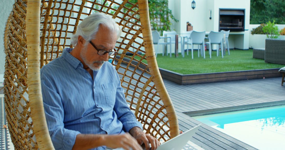 Senior Man Remote Working by Poolside at Home - Free Images, Stock Photos and Pictures on Pikwizard.com