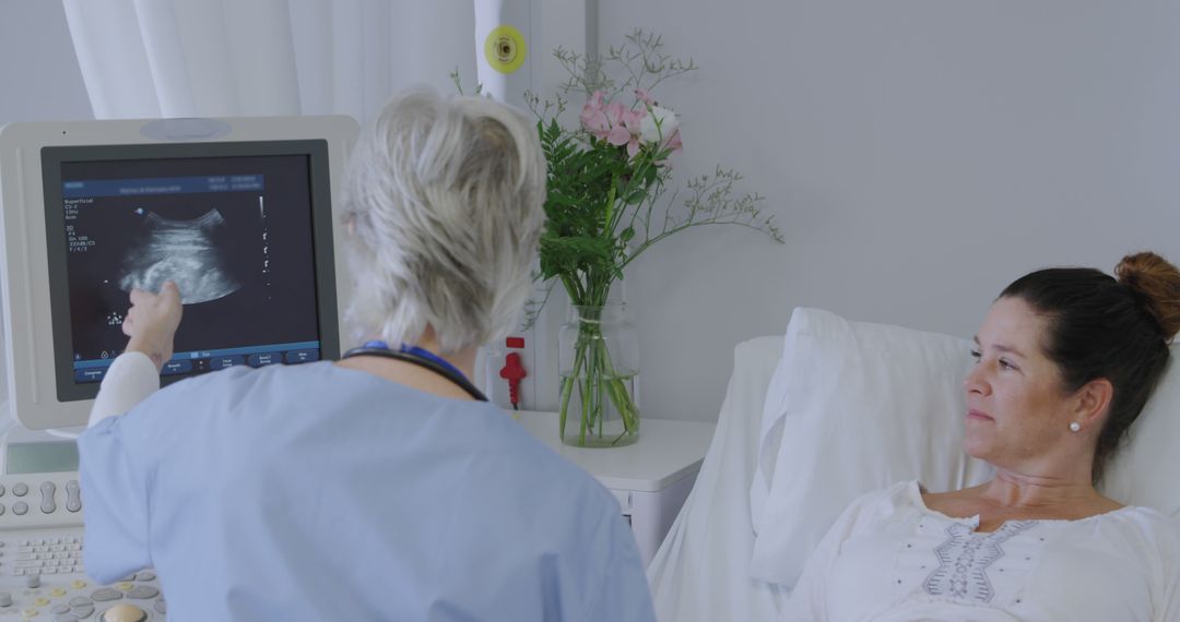 Doctor Examining Ultrasound Results with Patient in Hospital - Free Images, Stock Photos and Pictures on Pikwizard.com